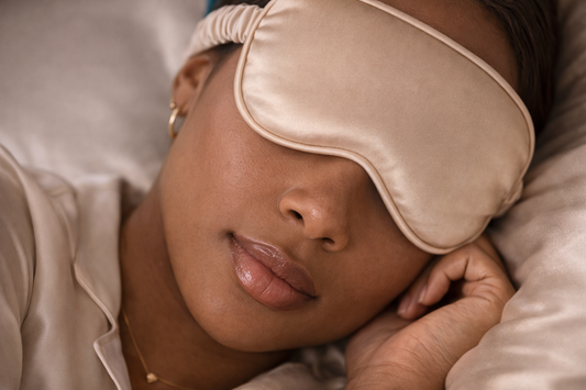 ASORA, Woman wearing a beige sleep mask, lying down with a neutral background