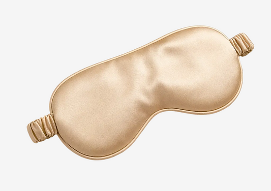ASORA, Champagne satin sleep mask on a light beige background