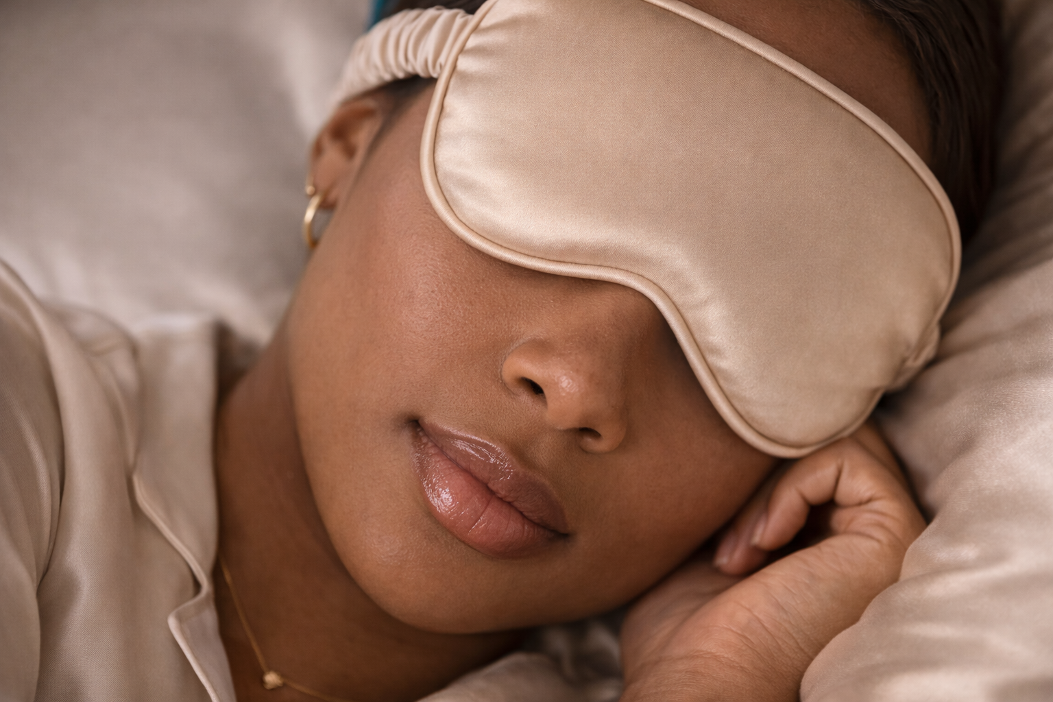 ASORA, Woman wearing a beige sleep mask, lying down with a neutral background