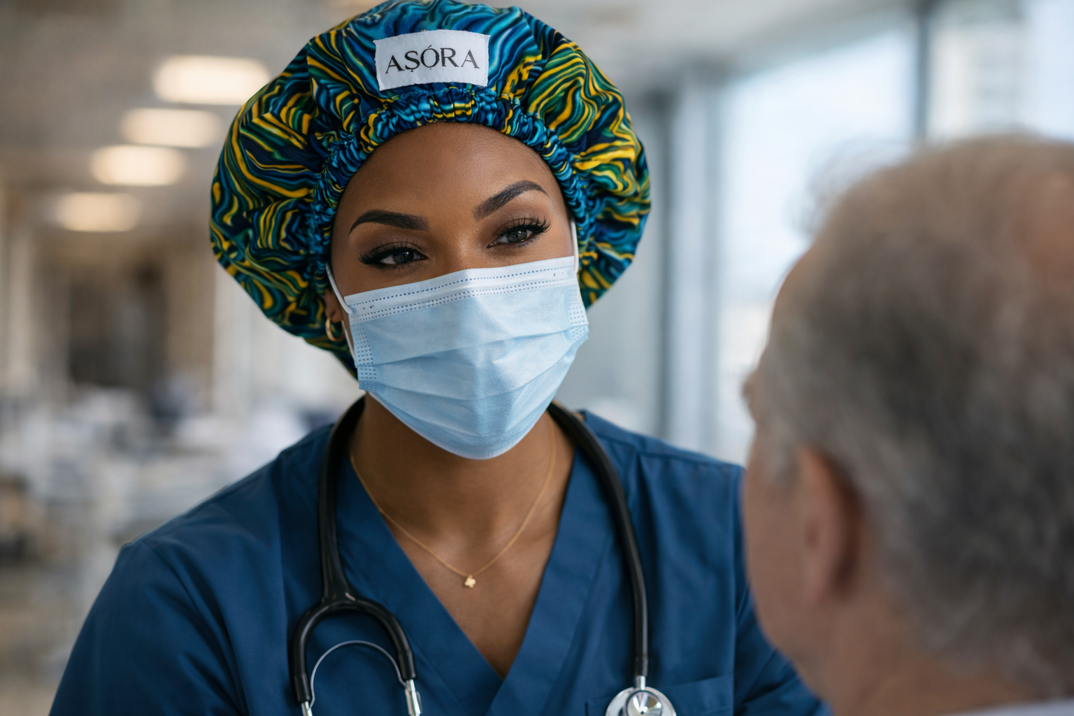 ASORA bonnet, Nurse wearing an 'ASORA' bonnet interacting with a patient in a hospital setting.