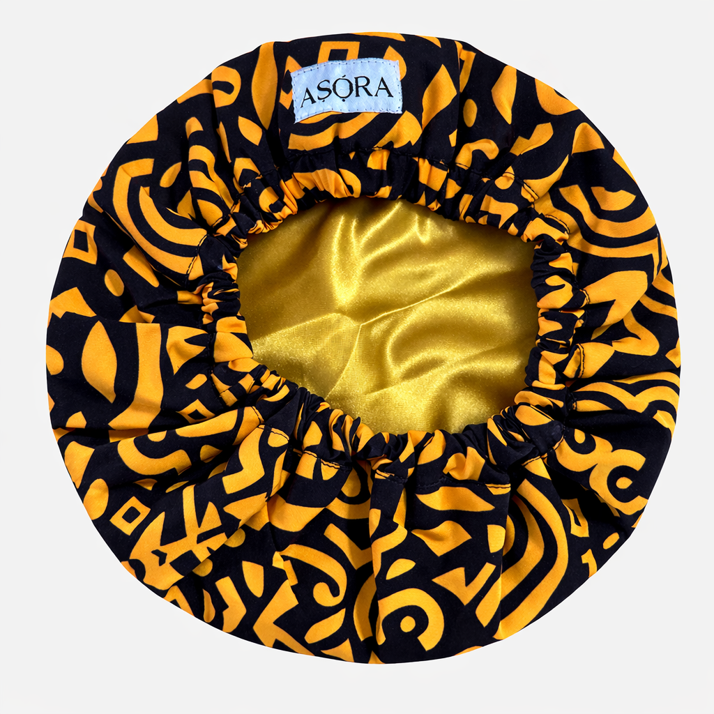 ASORA, Black and yellow patterned bonnet with gold interior on a white background, featuring the Asora brand.