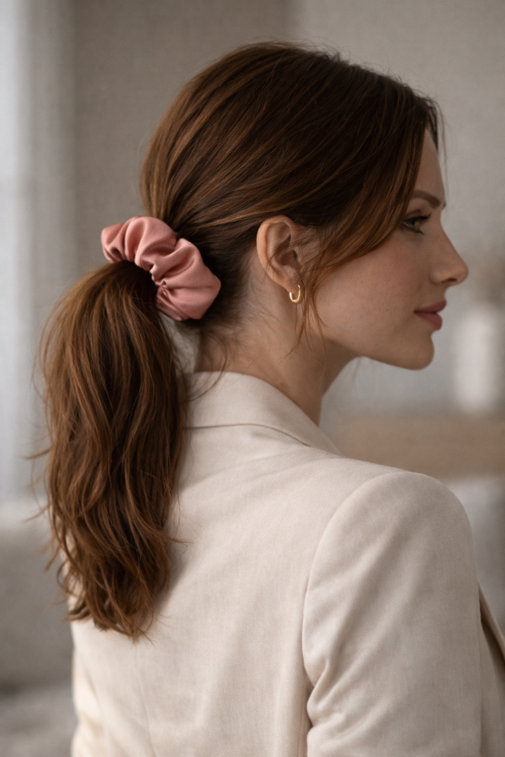 ASORA Silk Scrunchie, Woman with a pink scrunchie in her hair, wearing a white jacket.