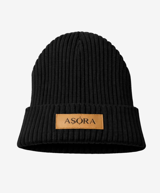 ASORA Black knit beanie with a brown leather patch displaying 'ASORA' on a white background