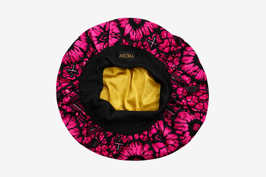 Pink and black patterned ASORA Crown bonnet with yellow interior on a white background